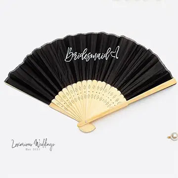a black and gold fan with the word bridesmaid written on it