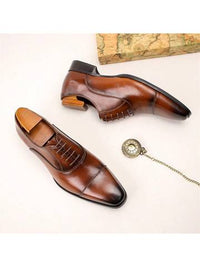 a pair of brown shoes and a chain