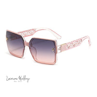 a pair of sunglasses with a pink frame