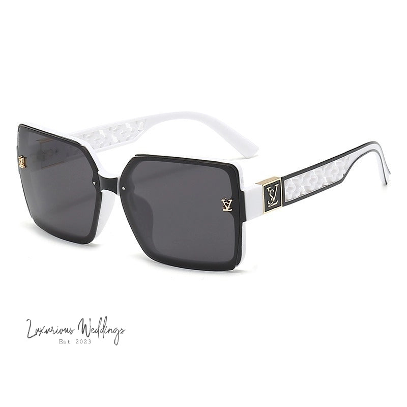 a pair of sunglasses with a white and black frame