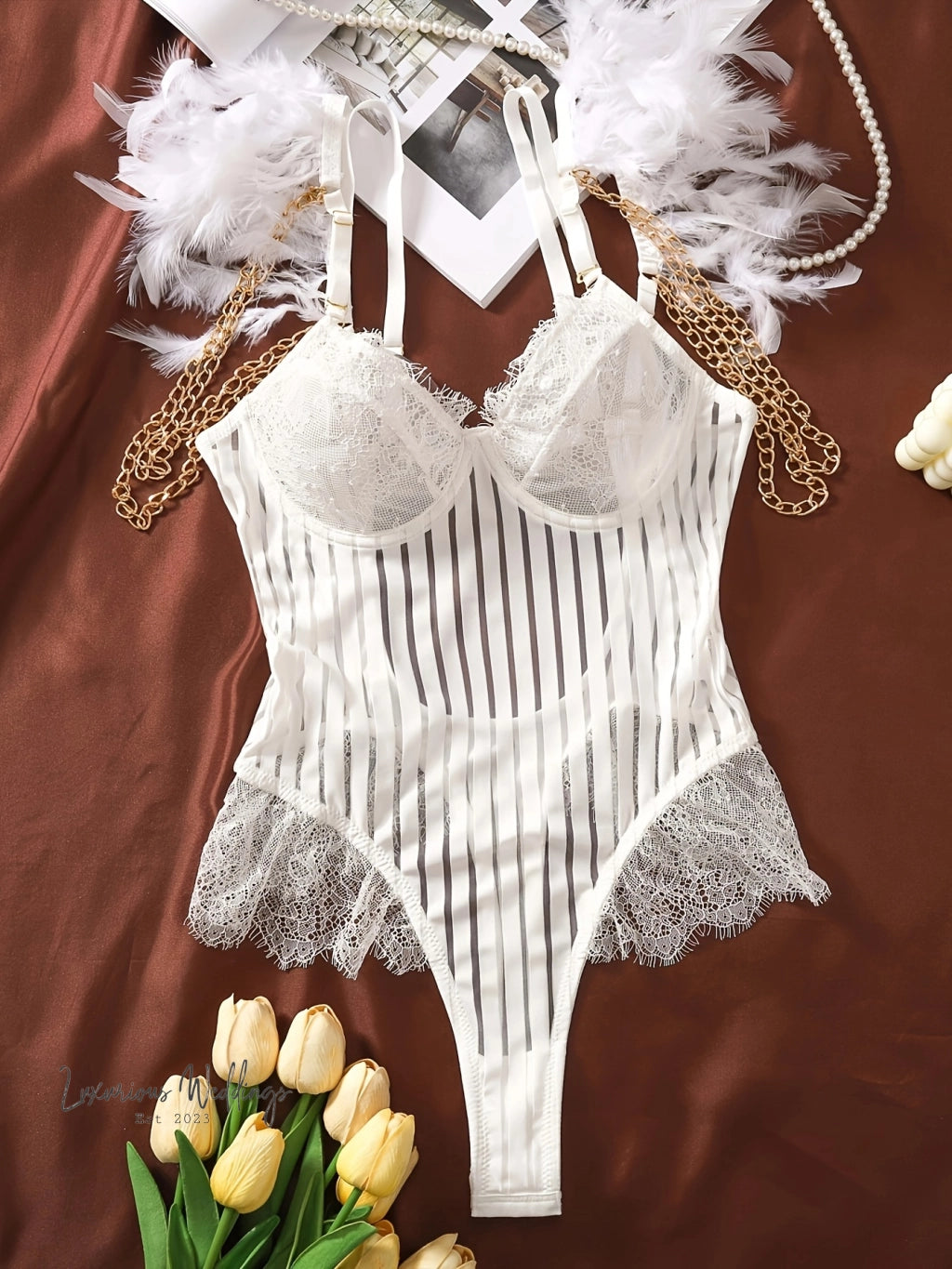 a white lingerie with white feathers and a bouquet of tulips