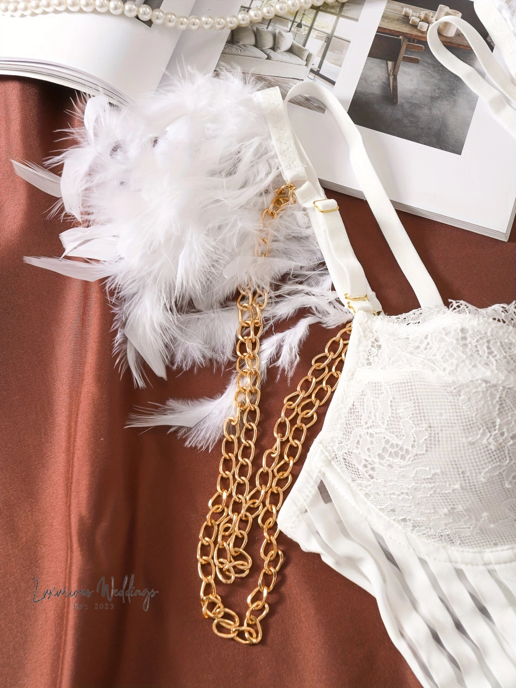 a white bra with feathers attached to it