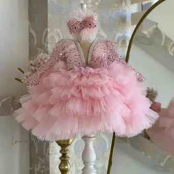 a little girl's pink dress on a stand