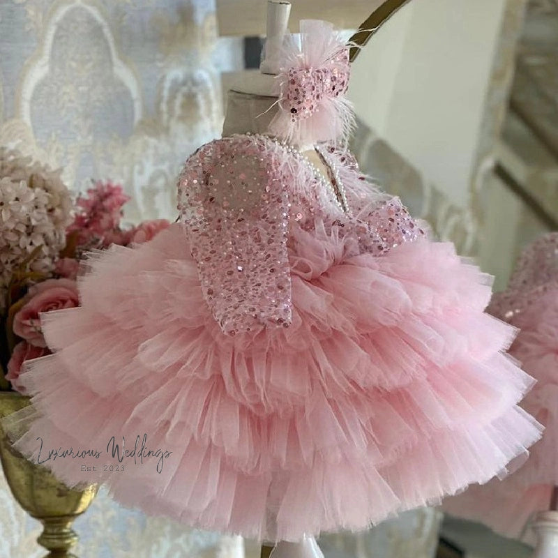 a little girl's pink dress hanging on a mannequin