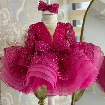 a mannequin wearing a pink dress with a bow
