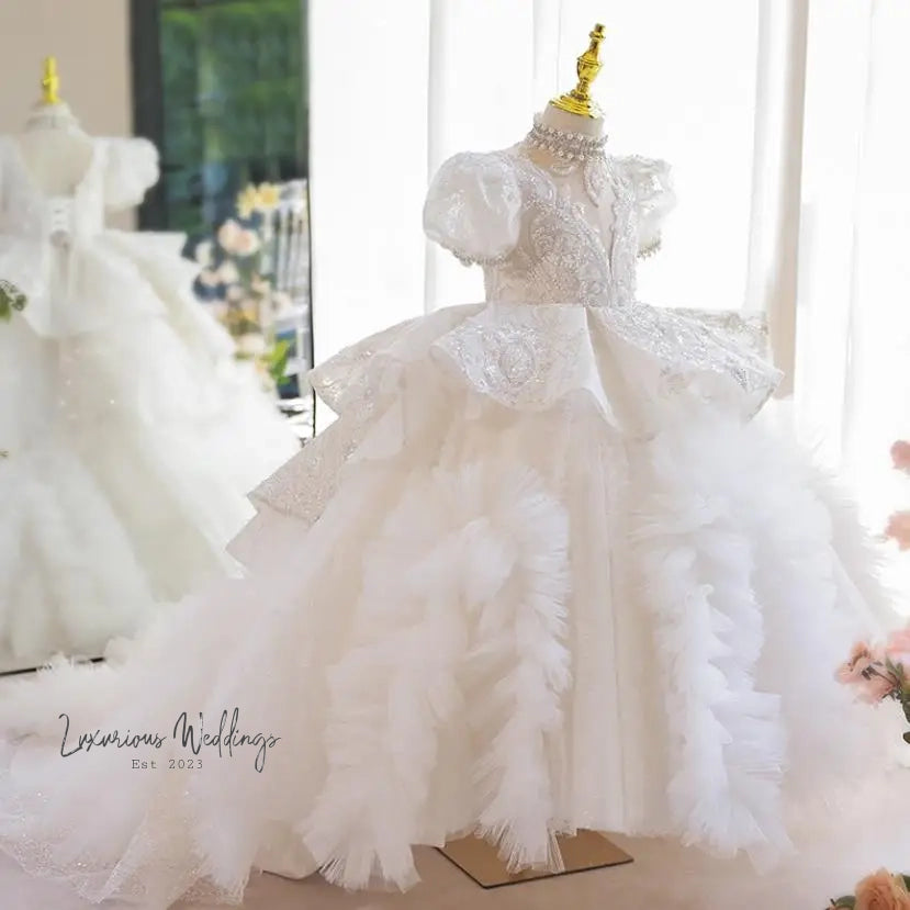 a white dress with a gold crown on top of it