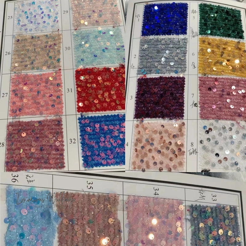 a table topped with lots of different colors of sequins