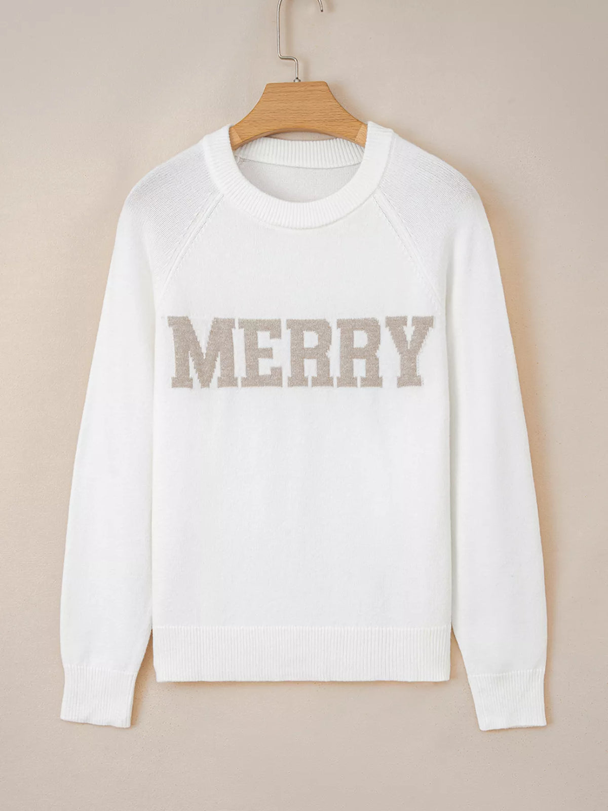 MERRY Letter Pattern Christmas Raglan Sleeve Sweater in white with beige lettering on hanging display.