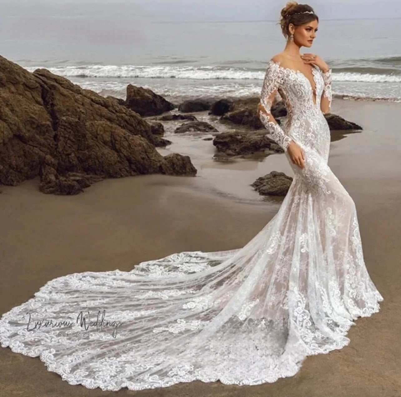 a woman in a wedding dress standing on the beach