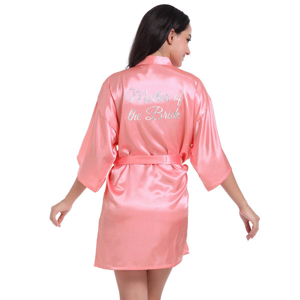 a woman in a pink robe with the words be the bride on it