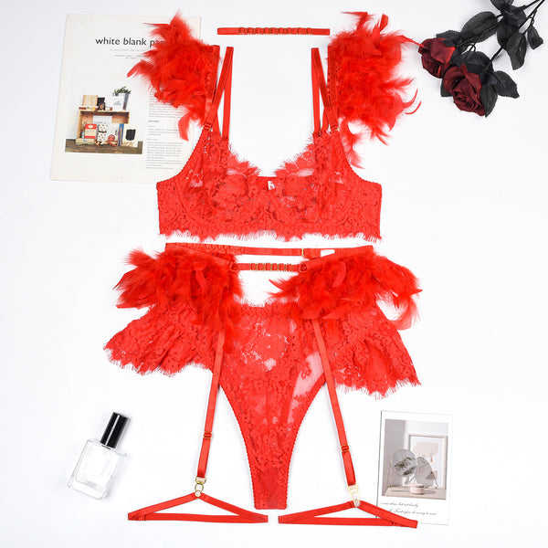 a woman's red lingerie and accessories laid out on a white surface