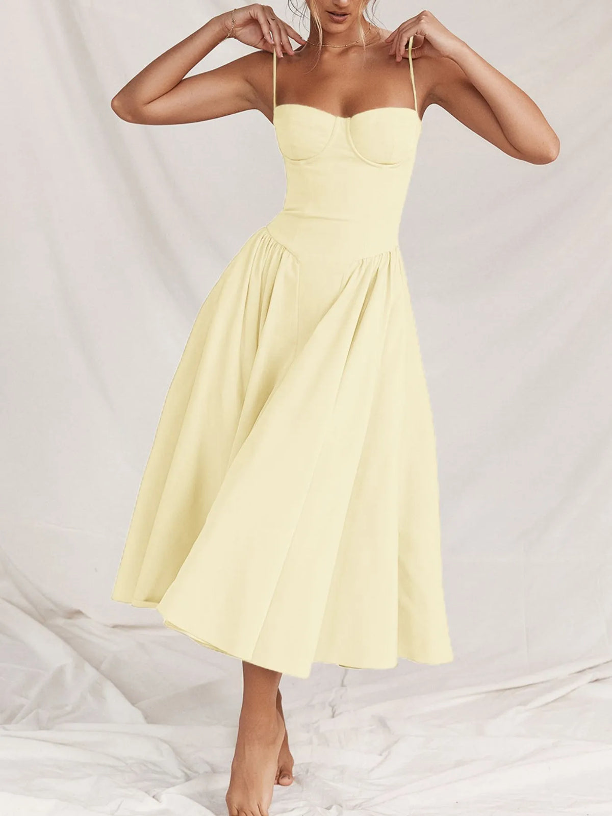 Ruched sweetheart neck cami dress in yellow, featuring a flowy A-line silhouette and adjustable straps.