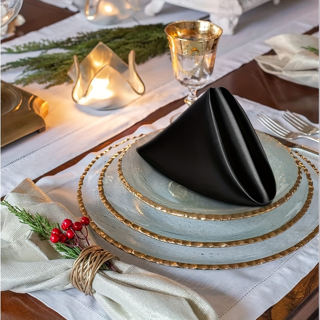 a table set for a holiday dinner with black napkins