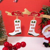 Christmas Cowboy Hat and Boot Dangle Earrings featuring red hat and white boot with 'HO HO HO' design