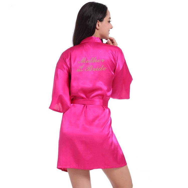 a woman is wearing a pink robe