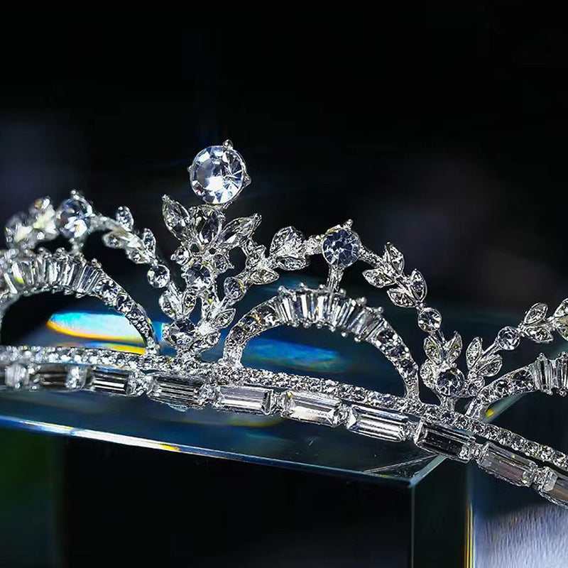 a diamond tiara on a glass stand