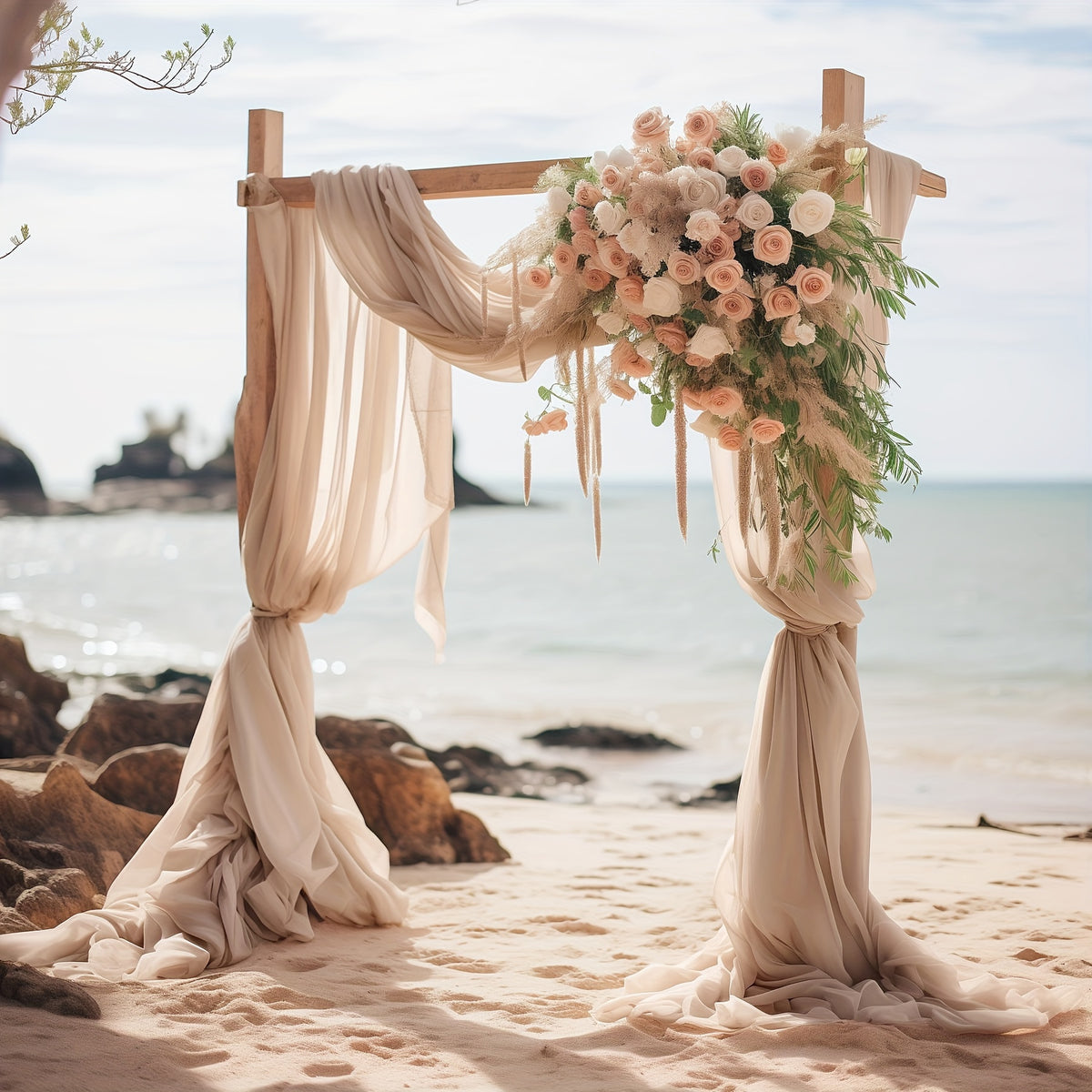 a wedding arch with flowers on the beach