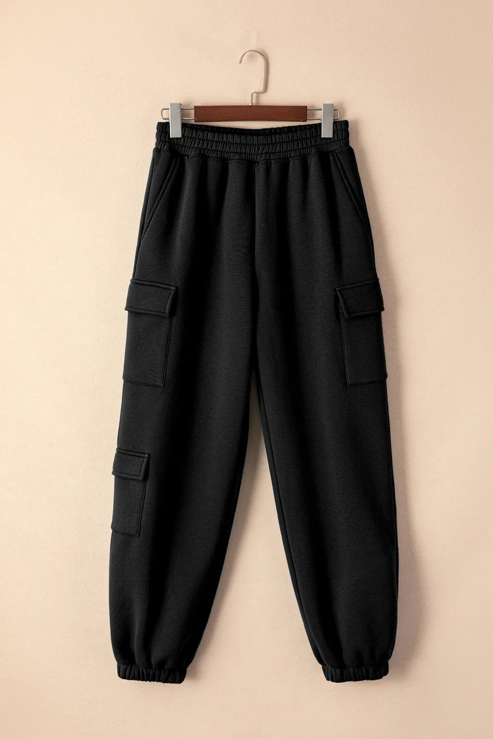 Black pocketed elastic waist joggers on display, perfect for affordable activewear and casual comfort.