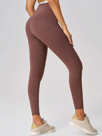 High waist active leggings in brown with a fitted design, showcasing a side view and paired with sneakers.