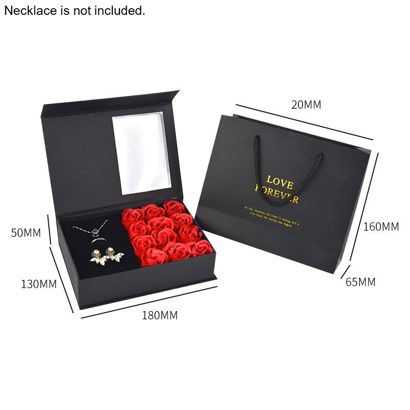 a box with a necklace and a rose in it