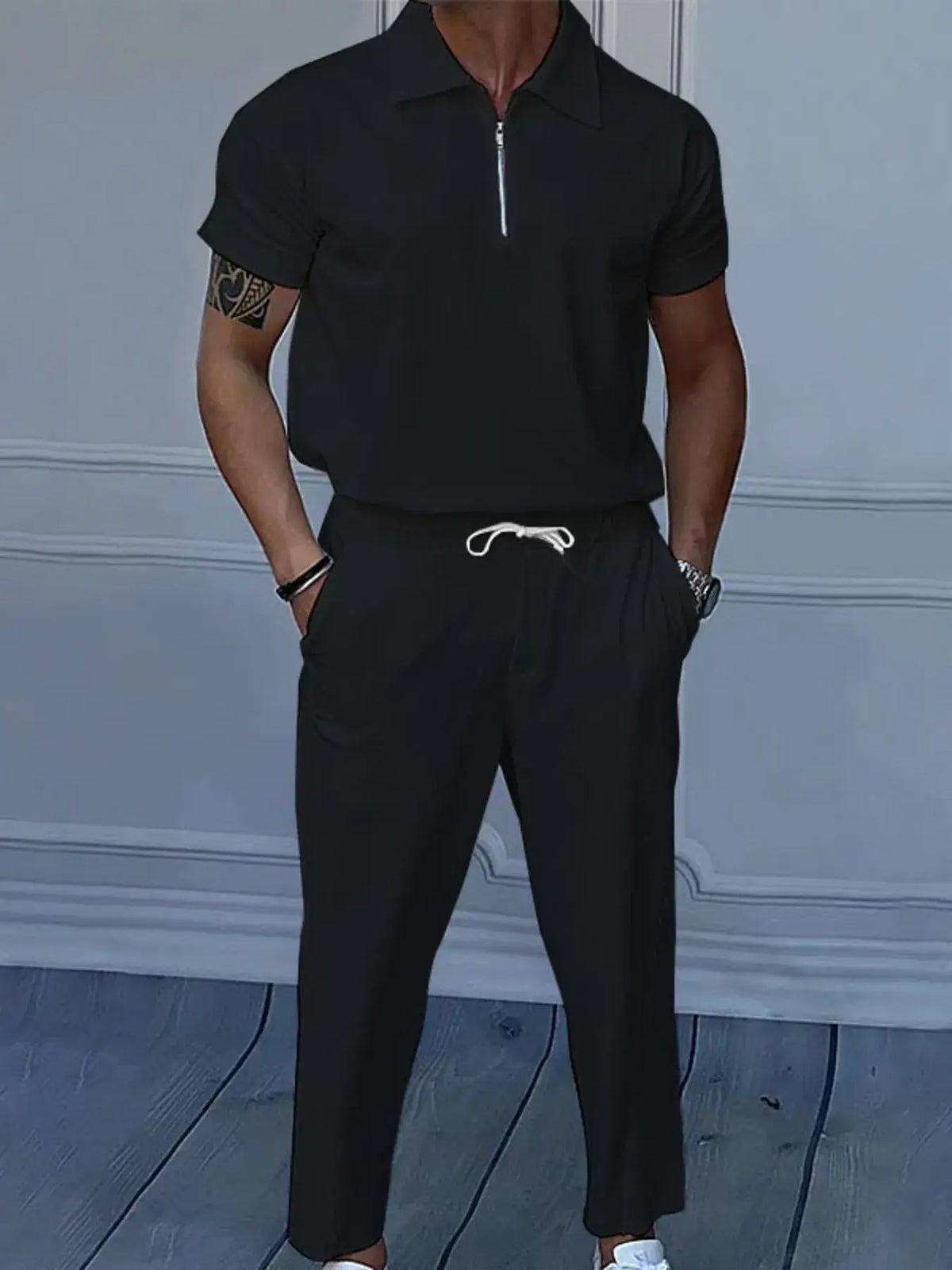 Men's black quarter zip short sleeve polo and pants set, featuring drawstring and pockets, ideal for casual formal wear.
