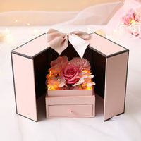 a pink box with flowers inside of it