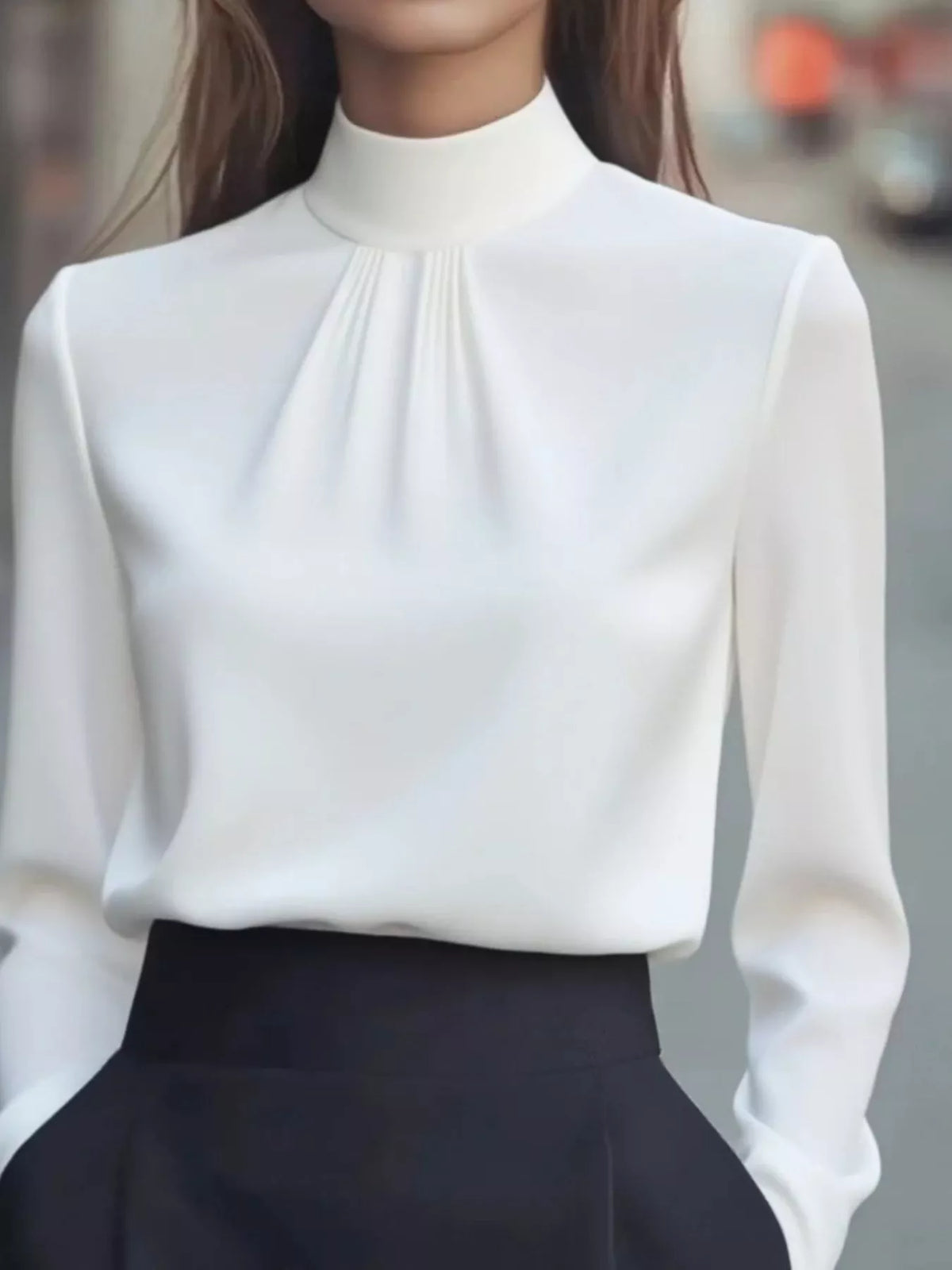 Mock Neck Long Sleeve Blouse with Pleated Detail in white fabric, featuring a sleek design and elegant pleated detail.