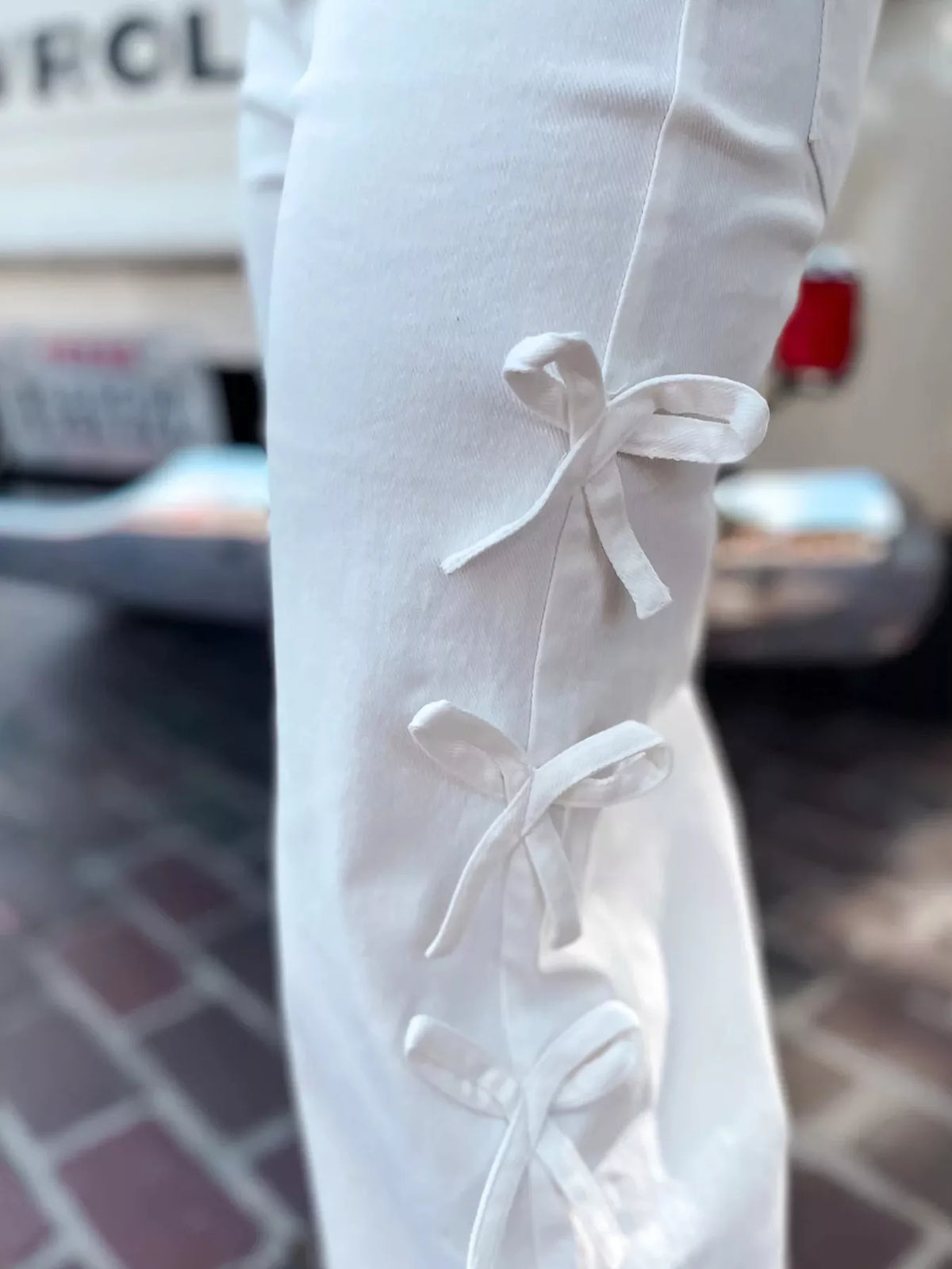 Close-up of Bow-Accented Wide-Leg Pants featuring decorative bows on the side for stylish detail.