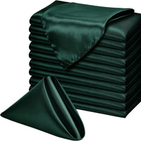 a stack of folded green satin sheets