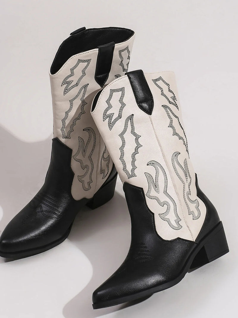 Stylish black and white point toe block heel boots with unique silver designs, perfect for a fashionable look.