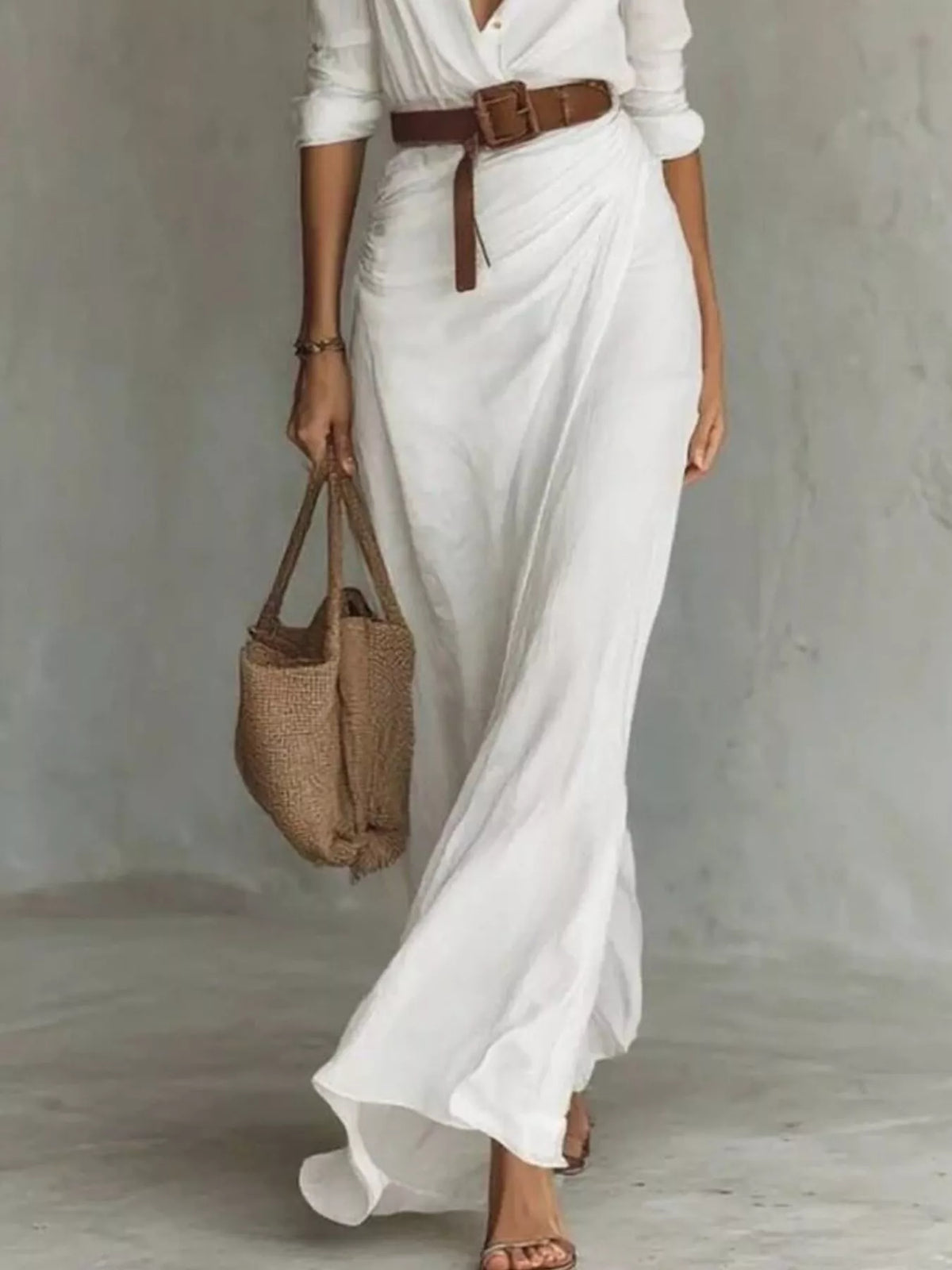 Full Size Ruched Long Sleeve Maxi Dress Plus Size worn with a brown belt and a woven bag, showcasing elegant summer style.