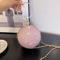 Luxurious pink spherical handbag with ring handle, perfect for elegant weddings and stylish occasions.
