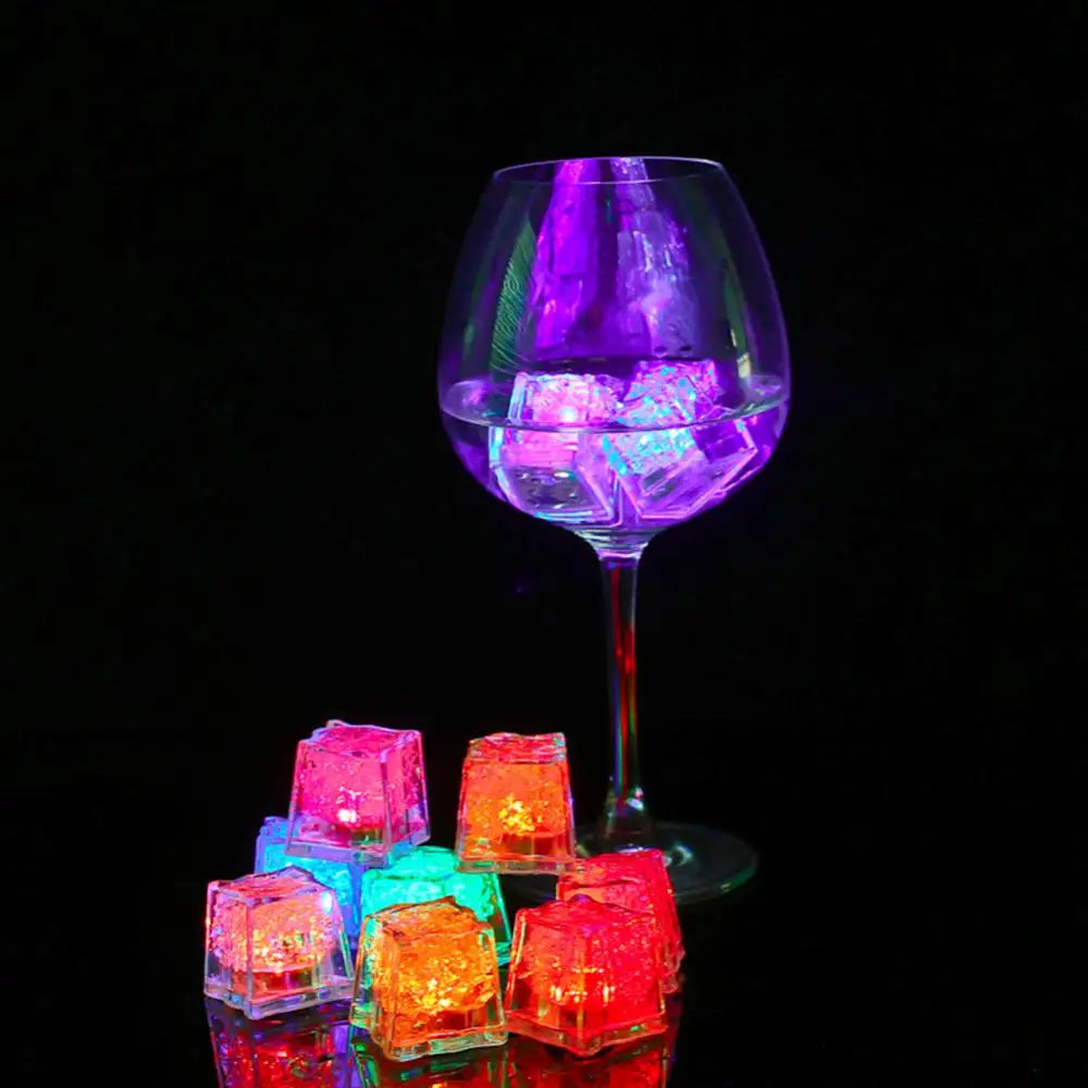 a wine glass filled with ice cubes on top of a table