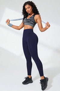 Model showcasing high waist active leggings in navy, perfect for workouts and casual wear.