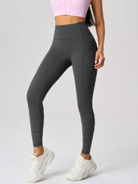 High waist active leggings in dark gray with pockets, featuring moderate stretch for comfort and style.