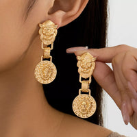 18K Gold-Plated Lion Head Medallion Drop Earrings showcased by model, highlighting their intricate design and shine.
