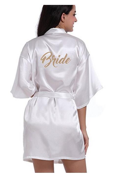 a woman wearing a white robe with the word bride on it