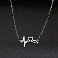 a necklace with a heartbeat and a heart on it