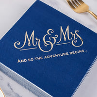 a blue wedding guest book with a gold fork and knife