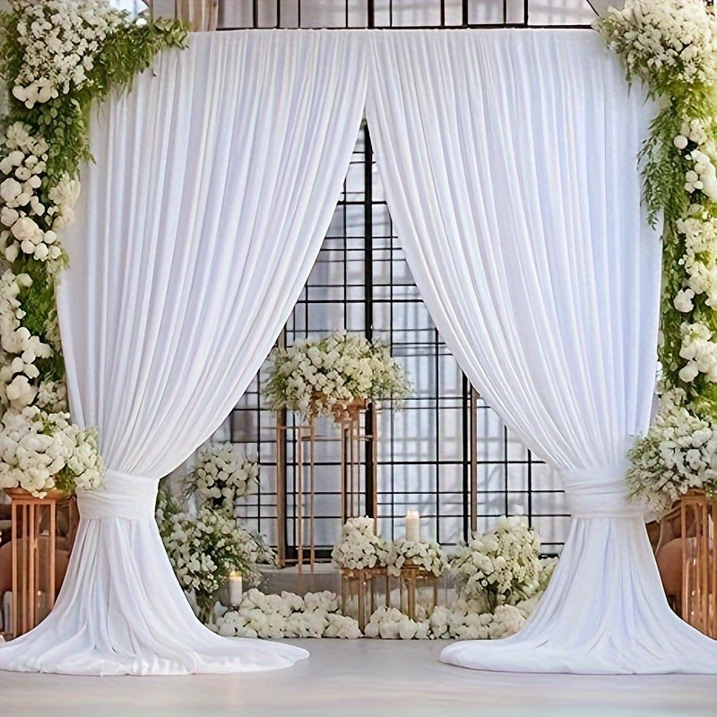 a wedding ceremony with white drapes and flowers