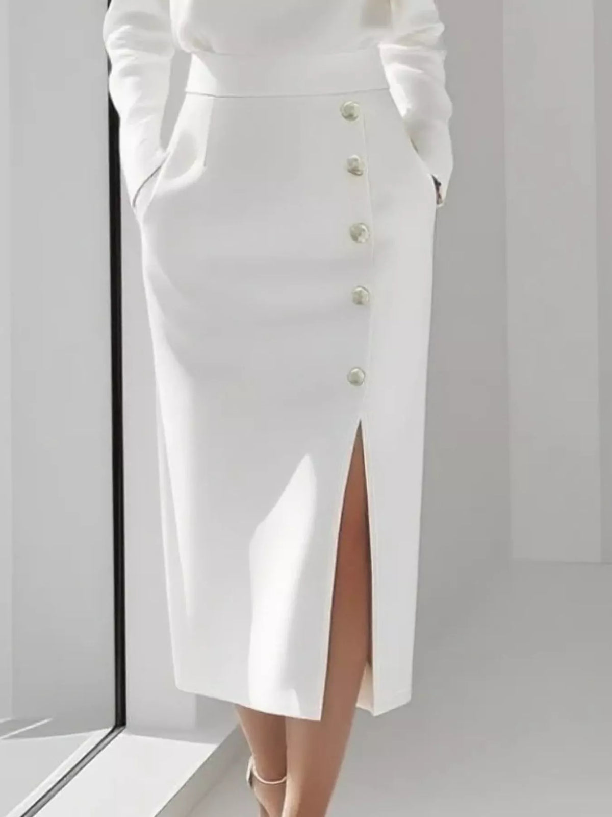 Long Sleeve Button Detail Midi Dress with Side Slit featuring a white skirt with button details and a side slit.