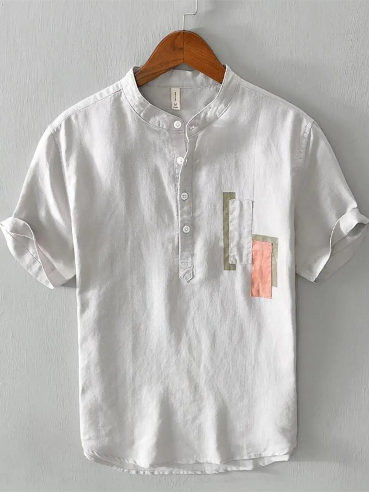 Men's plus size geometric contrast half button T-shirt in white with colorful accents, perfect for casual wear.