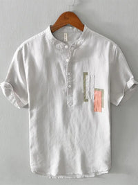 Men's plus size geometric contrast half button T-shirt in white with colorful accents, perfect for casual wear.