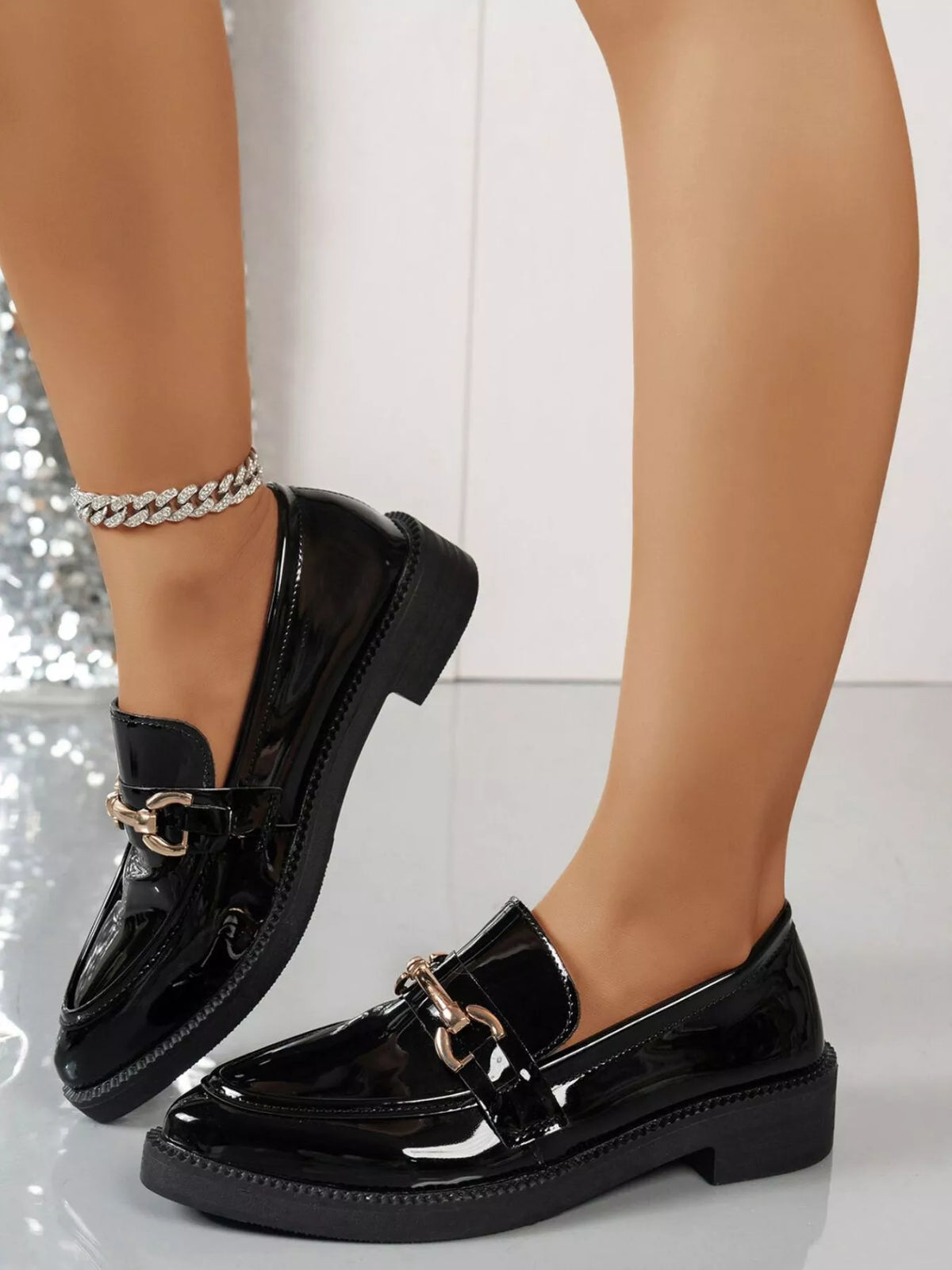 Black patent leather point toe block heels loafers with metallic detail, perfect for stylish comfort.