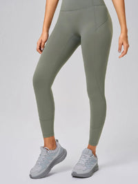 High waist active leggings in olive green with pocket, paired with light gray sneakers, ideal for workouts.