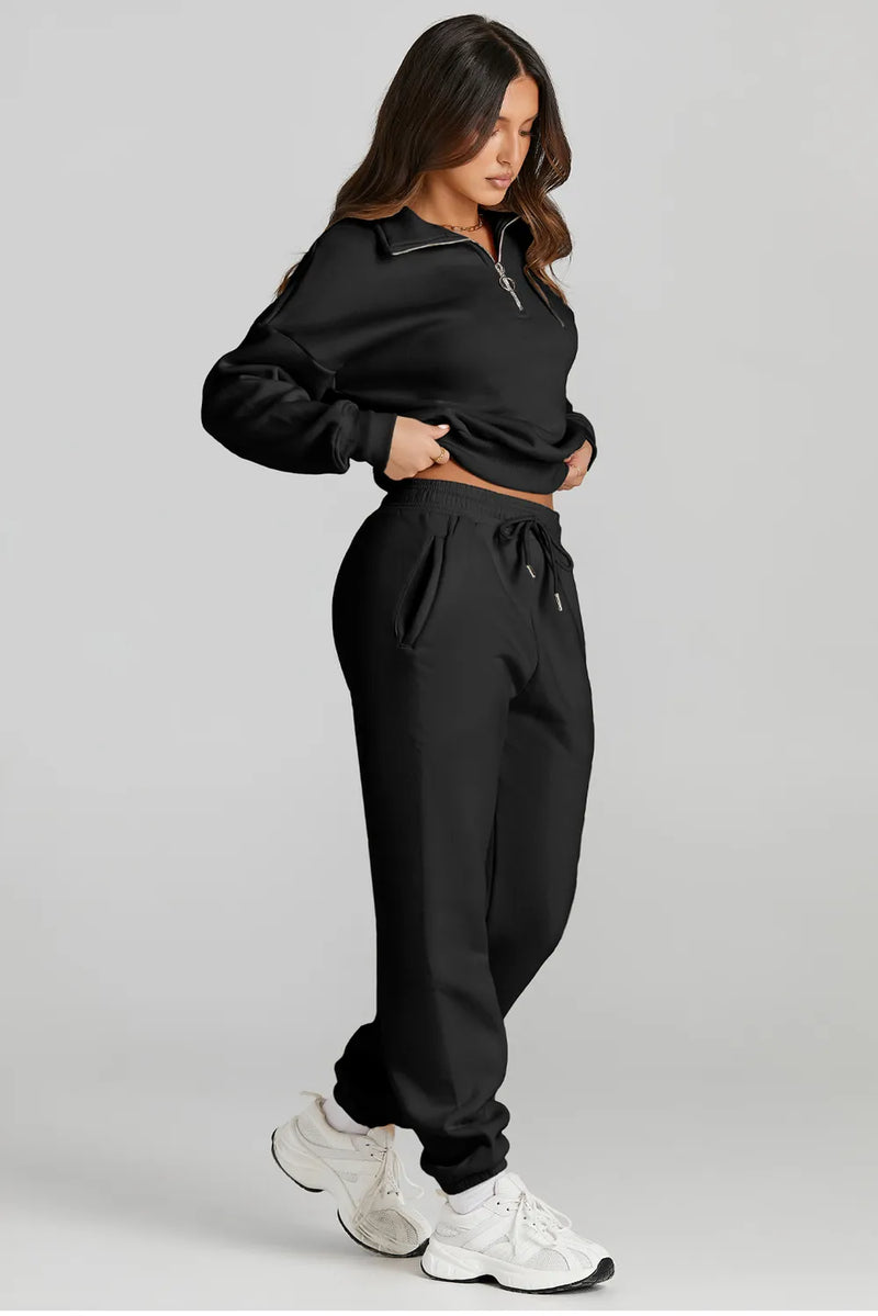 Stylish woman wearing a black quarter zip top and drawstring pants active set, showcasing affordable activewear.