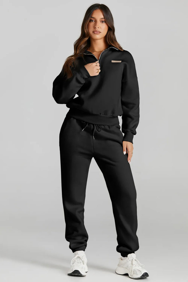 Model wearing a black quarter zip top and drawstring pants active set, showcasing affordable activewear.