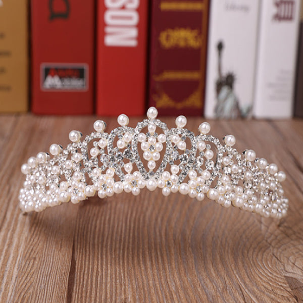 a tiara on a table with books in the background