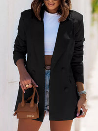 Stylish woman in a black lapel collar long sleeve blazer paired with denim shorts, perfect for luxurious weddings.
