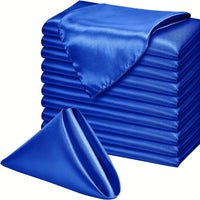 a stack of blue satin sheets with a folded one on top